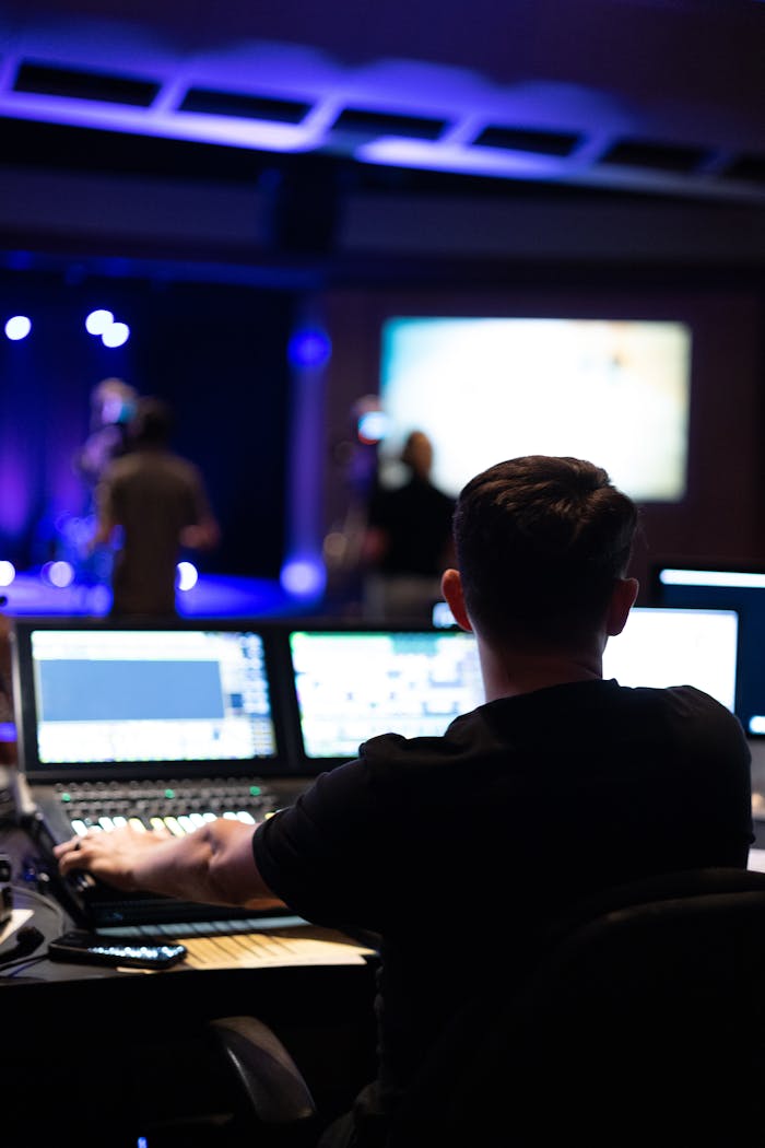 gallery-4 Sound engineer working at mixing console during a live studio performance.