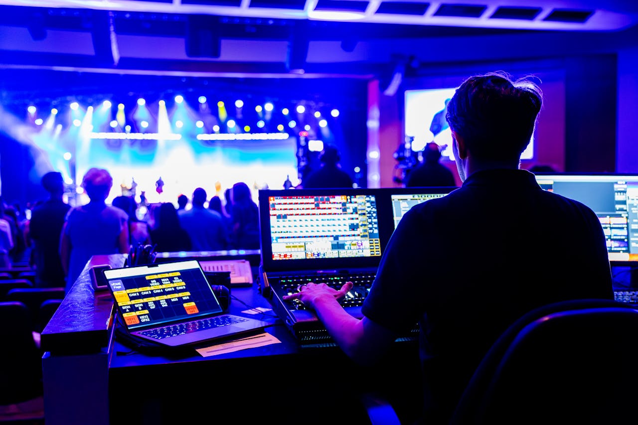 contact-img Professional technician managing lighting and sound at a live concert, showcasing modern technical skills.